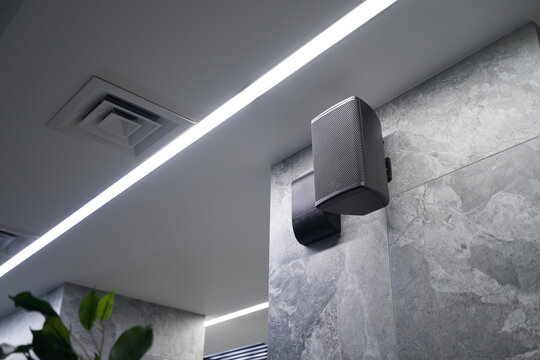 Black wall speaker installed in building sound system
