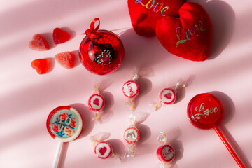Valentine's day concept with red hearts and candies on wooden table
