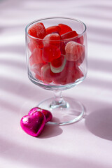 Valentine's day concept with red hearts and candies on wooden table