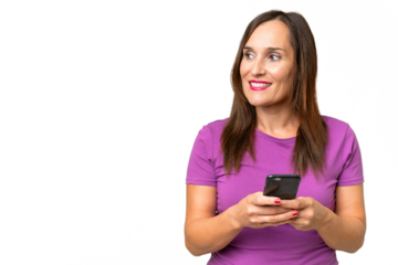 Middle-aged caucasian woman over isolated background using mobile phone and looking up