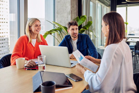 Young businessman discussing with colleagues over data in office