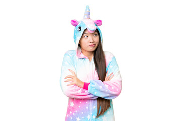 Obraz na płótnie Canvas Young Asian woman with unicorn pajamas over isolated chroma key background making doubts gesture while lifting the shoulders