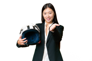 Young Asian woman with a motorcycle helmet over isolated chroma key background shaking hands for closing a good deal