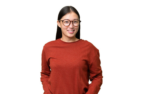Young Asian woman over isolated background suffering from pain in shoulder for having made an effort