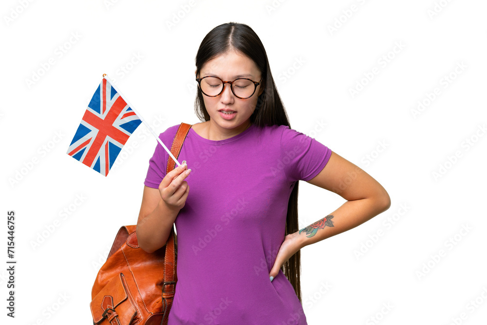 Wall mural Young Asian woman holding an United Kingdom flag over isolated background suffering from backache for having made an effort