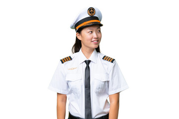 Airplane pilot Asian woman over isolated background looking side