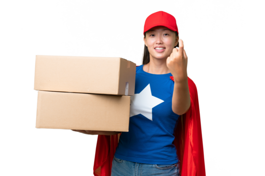Super Hero delivery Asian woman holding boxes over isolated background doing coming gesture
