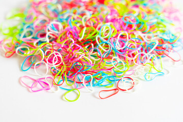 Colorful rubber bands or Mini Rainbow Purse Hair Bobbles, Colorful children's hair bands, flexible, made of para rubber, against white background.