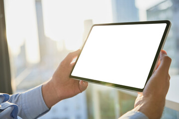Hands of businessman holding tablet PC with blank screen