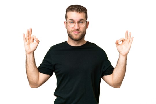 Young handsome blonde man over isolated chroma key background in zen pose