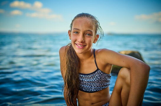 Girl sitting near lake Bolsena, Italy
