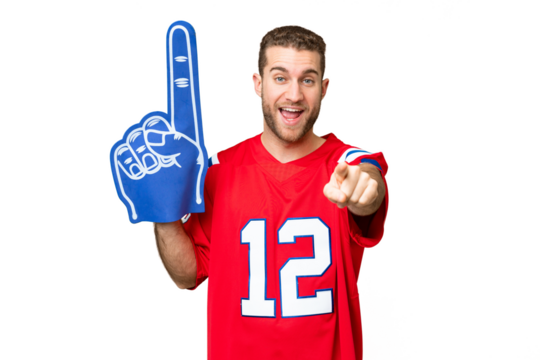 sports fan man over isolated chroma key background surprised and pointing front