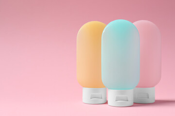 Cosmetic travel kit on pink background, space for text. Bath accessories