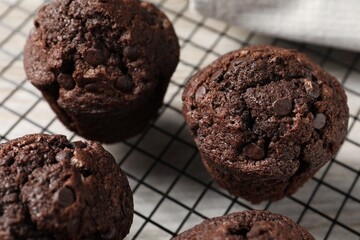 Delicious chocolate muffins on table, closeup view