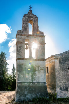 Greece, Ionian Islands, Karousades, Sun shining through arches of old stone bells