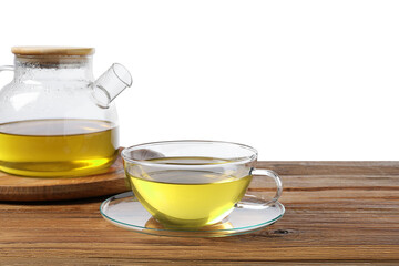 Refreshing green tea in cup and teapot on wooden table against white background