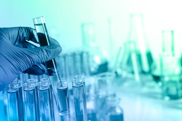 Laboratory worker holding test tube, closeup. Color toned