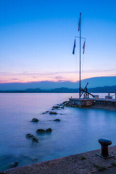 Italy, Veneto, Bardolino, Long exposure of marina on lake Garda at dusk