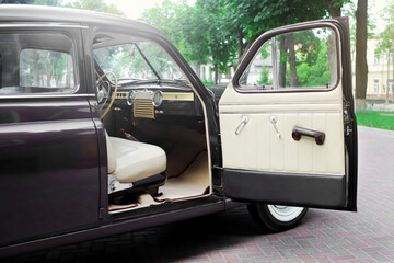 retro car interior. Vintage dashboards. Luxury leather steering wheel. Auto controls.
White interior. Car chairs and seats. Car sofa. Back and front row. Interior and door trim. Classic look