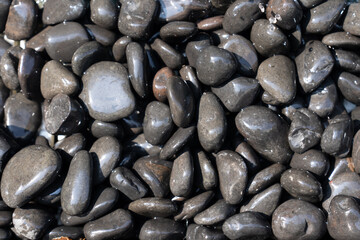 Several stones Stacked up beautifully The surface is smooth and rounded. and reflects light on the shiny surface