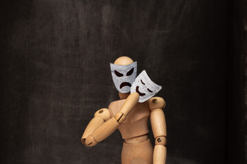 Angry, scary mannequin puts on positive cute mask, concept of danger, deception.