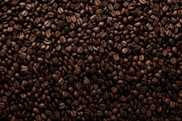 Fototapeta premium Close up view of dark fresh roasted coffee beans on coffee beans background. Closeup of coffee beans scattered background