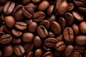 Close up view of dark fresh roasted coffee beans on coffee beans background. Closeup of coffee beans scattered background