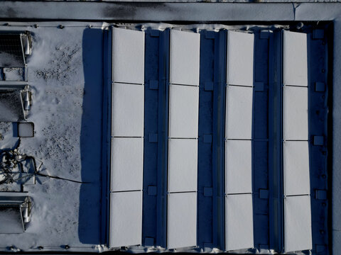 water heating in collectors on gable and flat roofs work when sun is shining. frost covered with layer of snow or frost must be plastered, otherwise effectiveness will recuced in row white silhoulett
