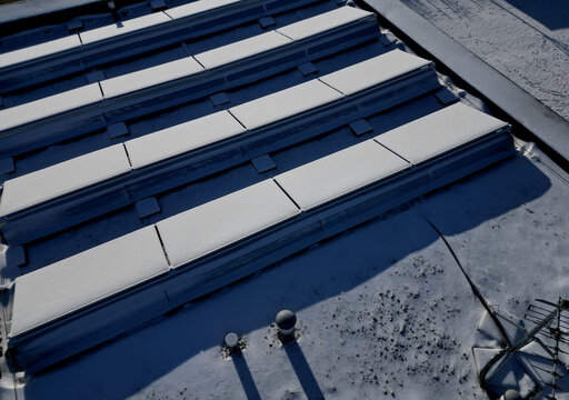 water heating in collectors on gable and flat roofs work when sun is shining. frost covered with layer of snow or frost must be plastered, otherwise effectiveness will recuced in row white silhoulett
