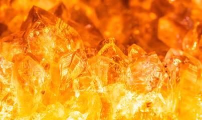 Golden crystal mineral stone. Gems. Mineral crystals in the natural environment. Texture of precious and semiprecious stones. Seamless background with copy space.