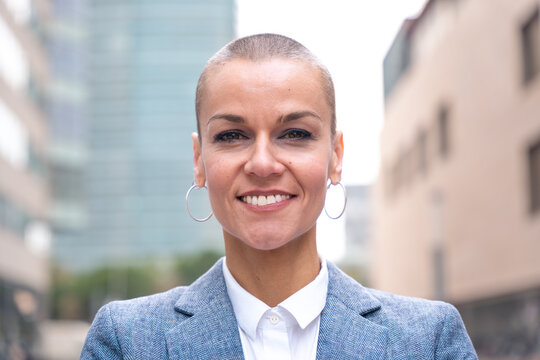  portrait of smiling businesswoman looking at camera outdoors