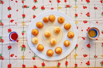 top view of profiteroles circle on a festive tablecloth
