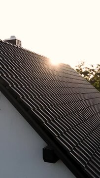 Dark Tiled Roof of a Single-Family Home at Sunset