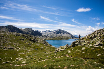 Young hiker girl summit to Montardo Peak in AIguestortes and Sant Maurici National Park, Spain