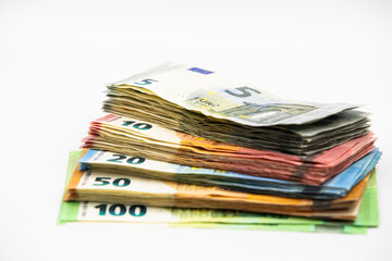 Pile of euro banknotes of 100, 50, 20, 10 and 5 euros. White background