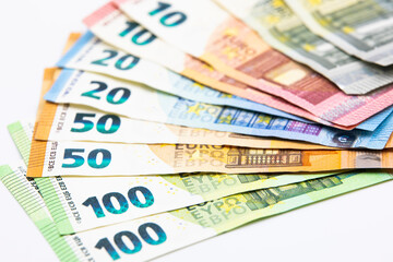 Pile of euro banknotes of 100, 50, 20, 10 and 5 euros. White background