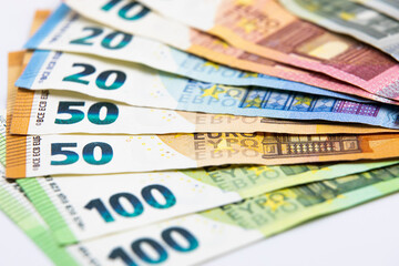 Pile of euro banknotes of 100, 50, 20, 10 and 5 euros. White background