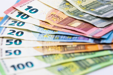 Pile of euro banknotes of 100, 50, 20, 10 and 5 euros. White background