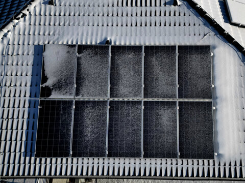 water heating in collectors on gable and flat roofs work when sun is shining. frost covered with layer of snow or frost must be plastered, otherwise effectiveness will recuced in row white silhoulett
