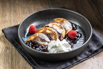 Pancakes with blueberry jam and raspberries in a bowl