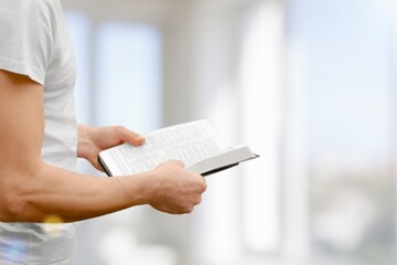 Pastor holds a bible book in hand