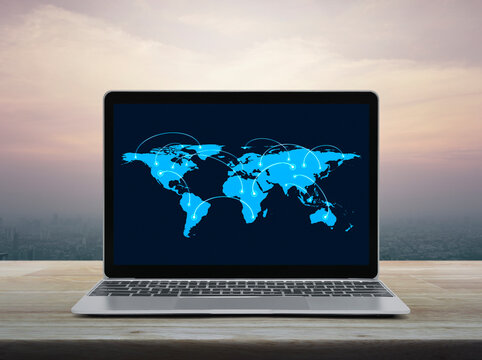 Connection line with global world map on laptop computer screen on table over city at sunset sky, vintage style, Business communication online concept, Elements of this image furnished by NASA