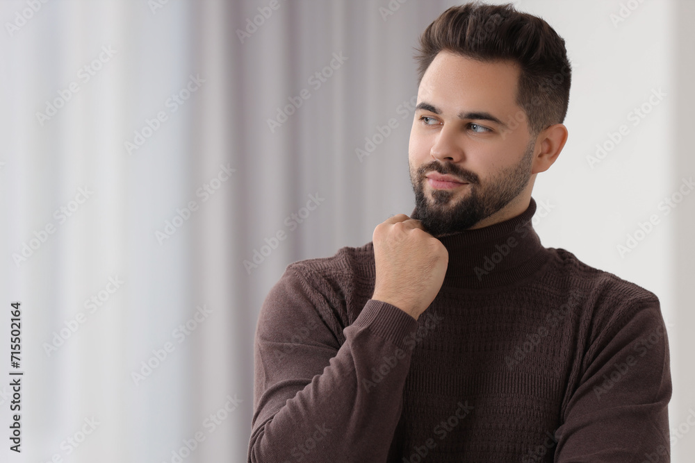 Wall mural Handsome man in stylish sweater indoors, space for text - Wall murals