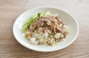 fried salty slice beef meat with garlic and pepper on rice in plate
