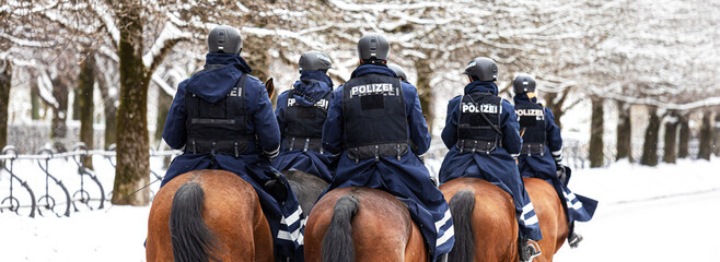 german police on horses in winter panorama