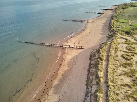 Aerial view of beach and dunes at Dawlish Warren, guarding the mouth of the River Exe, looking south along the coast towards the town of Dawlish, Devon, England