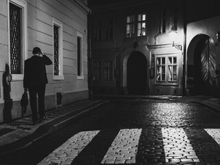 man in suit at the old town street at night