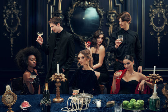 Luxurious party for high-society meeting. Wealth young people, young men and women, friends in stylish clothes meeting in luxury place for dinner. Concept of upper-class, holidays, party, royalty