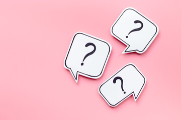 Question marks on paper speech bubbles, top view. Ask and answer concept
