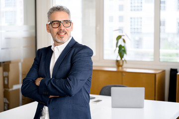 Inspired proud prosperous mature gray-haired businessman ceo manager wearing suit standing in...